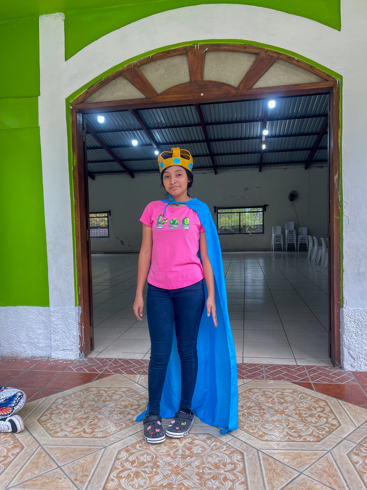 A teen in a crown and cape at an UrbanPromise program